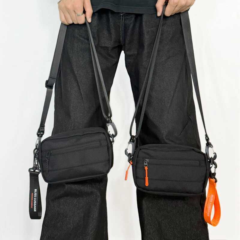 BLISS LUGGAGE กระเป๋าสะพายข้างสีดำ สายสีส้มแต่งหน้า วัสดุไนลอนทนทาน ขนาดเล็ก พกพาสะดวก สำหรับผู้ชายผ