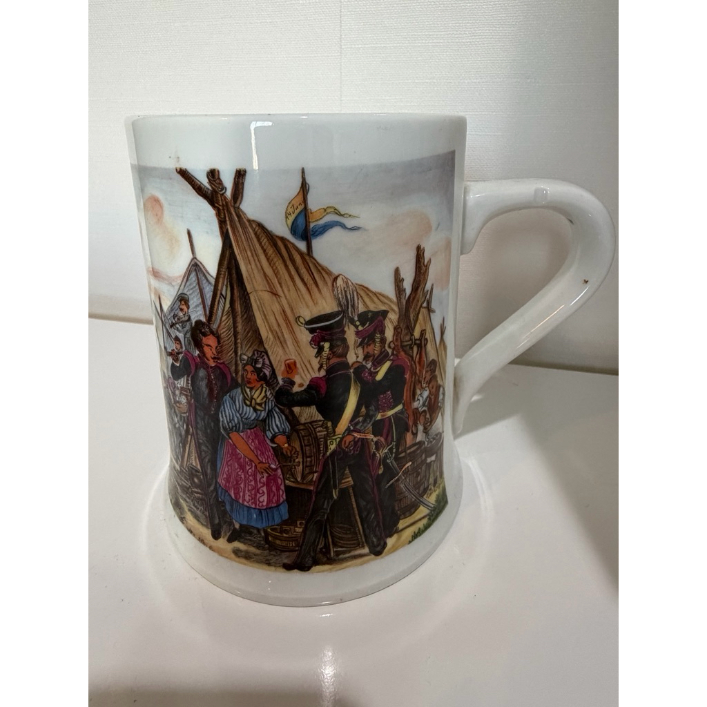 A ceramic beer mug featuring a 19th-century European military camp scene