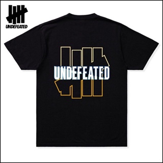 เสื้อยืดผู้ชาย Undefeated เสื้อยืด ผ้าฝ้าย พิมพ์ลายโลโก้ ไล่โทนสี แนวสตรีท สําหรับผู้ชาย และผู้หญิง