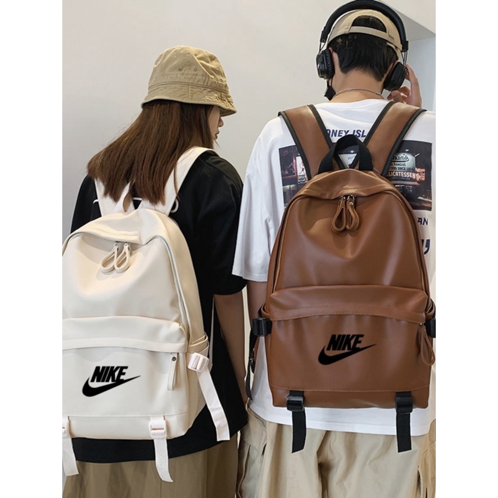 ✼▼▼Nike Nike กระเป๋านักเรียนกันน้ำความจุขนาดใหญ่ นักศึกษาหญิง กระเป๋าเป้คอมพิวเตอร์เรียบง่าย กระเป๋าเป้หนังสีขาว เด็กผู้