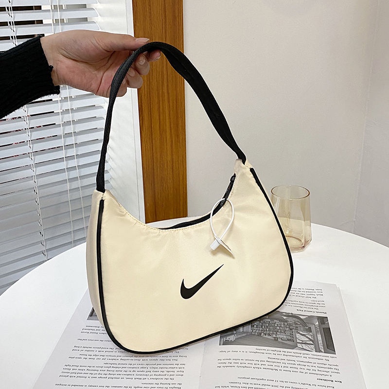 ┋♕Nike กระเป๋าใต้วงแขนผู้หญิง hobo กระเป๋าผ้าใบไนลอนย้อนยุคทรงบาแกตนักเรียนอเนกประสงค์กระเป๋าสะพายพก