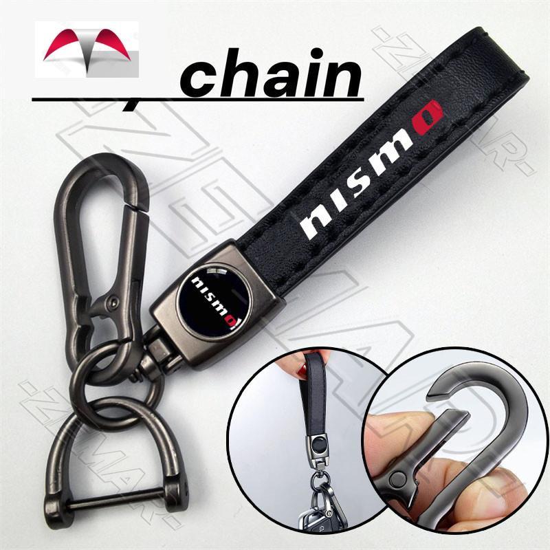 Nissan Nismo พวงกุญแจหนังโลหะ พวงกุญแจรถจักรยานยนต์ พวงกุญแจแขวนแฟชั่นระดับไฮเอนด์ รูปแบบการพิมพ์ Ni