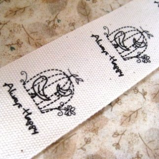 ป้ายผ้า cotton เนื้อหนาพิมพ์ลายนกน้อยในกรง ขนาด 4 ซม.ราคาหลาละ