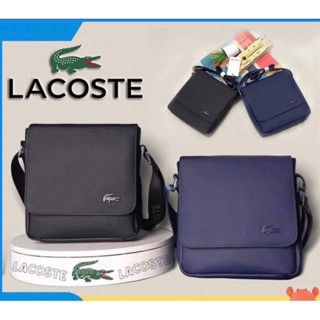 กระเป๋า LACOSTE สะพายผู้ชาย   สายปั๊มโลโก้ Lacoste สกรีนโลโก้ ลาคอส มี 2 สี  สีดำ   น้ำเงิน Size :  23.× 21 × 6 cm.