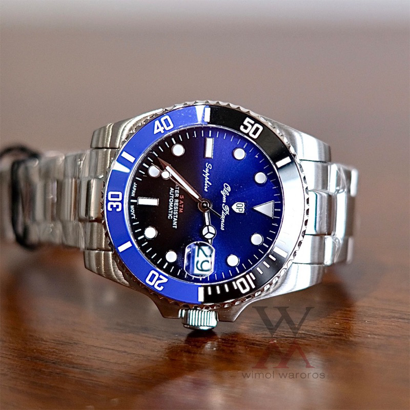 (ประกันศูนย์ไทย 1 ปี) OP (Olym Pianus) รุ่น 89983AG-423 (Submariner) Sapphire Automatic (หน้าน้ำเงิน/ดำ-ขอบน้ำเงิน/ดำ)