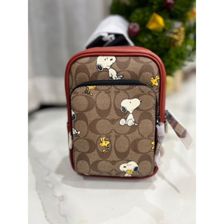 (ผ่อน0%) กระเป๋าคาดอก คาดหลัง 🔻Coach X Peanuts Track Pack 14 In Signature Canvas With Snoopy Print CE600 ลายซี สีส้ม