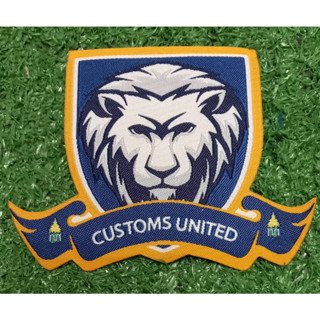 โลโก้ T2. สโมสรฟุตบอลCUSTOMS UNITED อาร์มทอของแท้ปี2022/2023