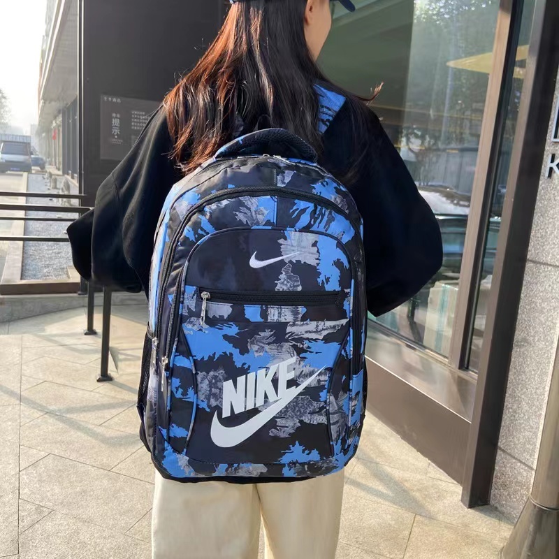 Nike ความจุขนาดใหญ่แฟชั่นผู้ชายและผู้หญิงกระเป๋าเป้สะพายหลังลายพรางกระเป๋าคอมพิวเตอร์สบาย ๆ