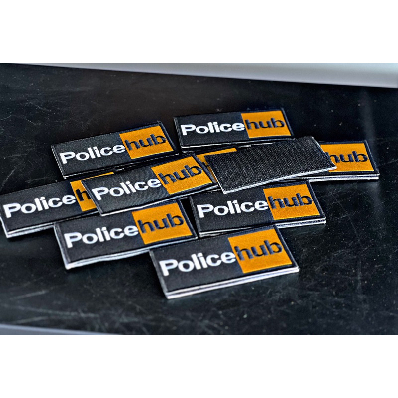 ป้าย police hub พร้อมเย็บตีนตุ๊กแกด้านหลัง
