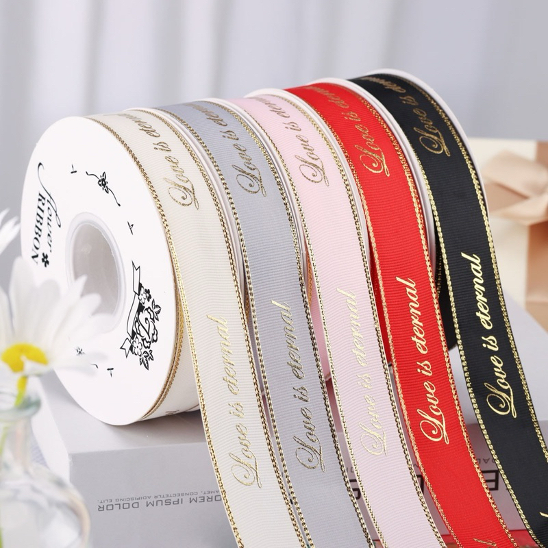 ริบบิ้นผ้าขอบทอง love is eternal 2.5 cm ยาว 25 หลา
