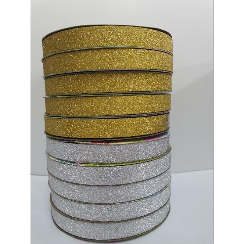 ริบบิ้นกากเพชร[1ม้วน]มีสีเงินสีทองแบบทึบNo.2ยาว50y.12mmตราTW