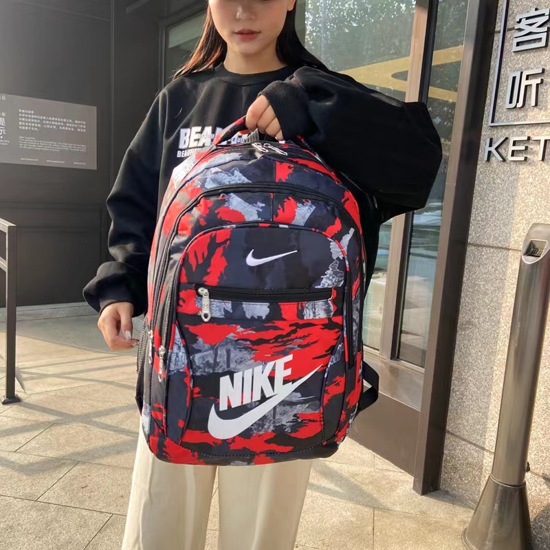 Nike ความจุขนาดใหญ่แฟชั่นผู้ชายและผู้หญิงกระเป๋าเป้สะพายหลังลายพรางกระเป๋าคอมพิวเตอร์สบาย ๆ
