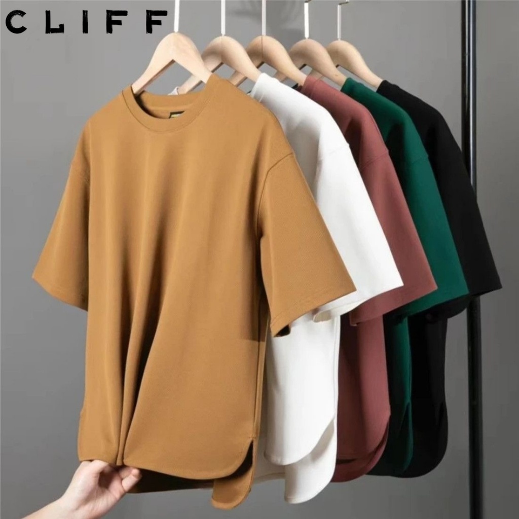 CLIFF เสื้อยืดผู้ชาย คอกลมแขนสั้นสีล้วน ชุดคู่รัก การออกแบบด้านหน้าสั้นและด้านหลังยาว รุ่นหลวม