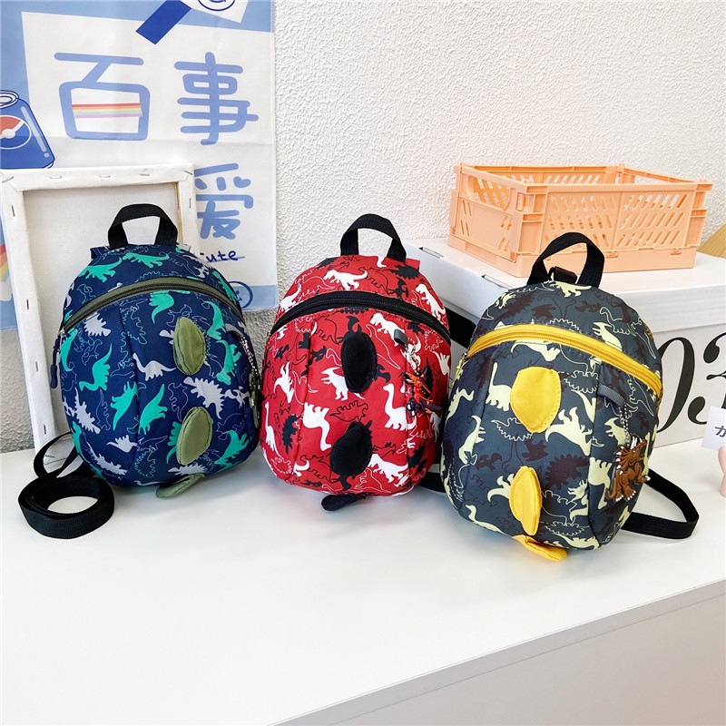 กระเป๋านักเรียนอนุบาล กระเป๋าเป้เด็ก การ์ตูนไดโนเสาร์น้อย ป้องกันการสูญหาย 24*21*11CM