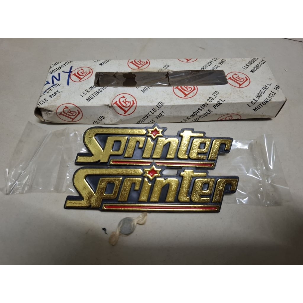 ตราโลโก้ฝากระเป๋าข้างซ้าย-ขวาแบบสีทองใส่ Suzuki Sprinter100-110 ของใหม่งานเก่าเก็บ(ไม่แท้)งานสวยๆเลยพร้อมใส่ใช้งานได้เลย