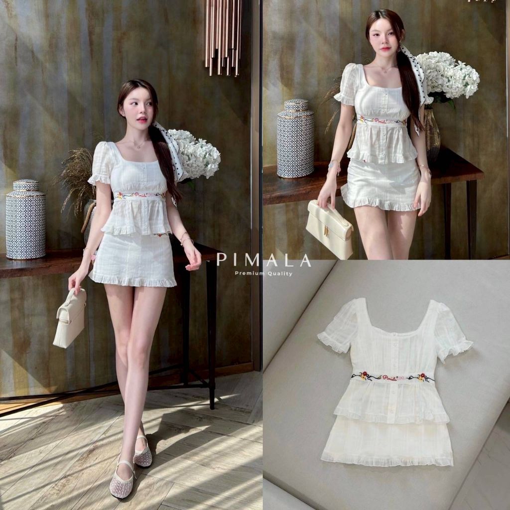 Pimala เซ็ทเสื้อแขนสั้น เป็นงานปักดอกไม้ แขนตัวเสื้อกระโปรงเป็นจีบระบาย มาคู่กับกระโปรงสั้นสีขาว