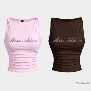 เสื้อแขน​กุด​ ลาย​ตัวอักษร​ แต่ง​พลอย​เทียม​ บิดเกลียว​ เข้า…