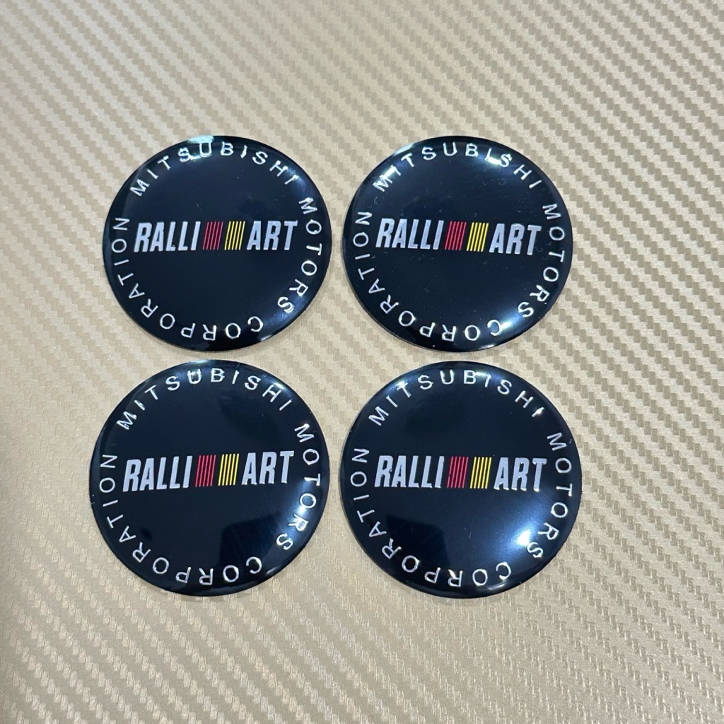 โลโก้ สติ๊กเกอร์ RALLI ART โลโก้ฝาครอบล้อ โลโก้ติดดุมล้อ ขนาด : เส้นผ่าศูนย์กลาง 56 mm (ราคาต่อชุด มี 4 ชิ้น )