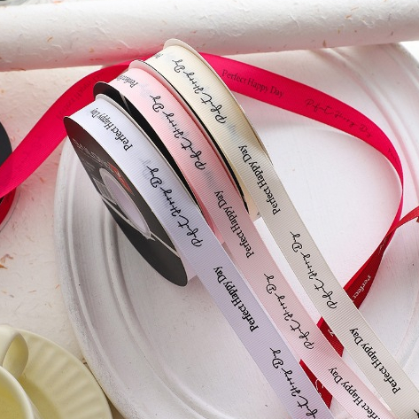 ริบบิ้นพิมพ์ข้อความ “Perfect Happy Day”  กว้าง 1.5 ซม.Printed Ribbon