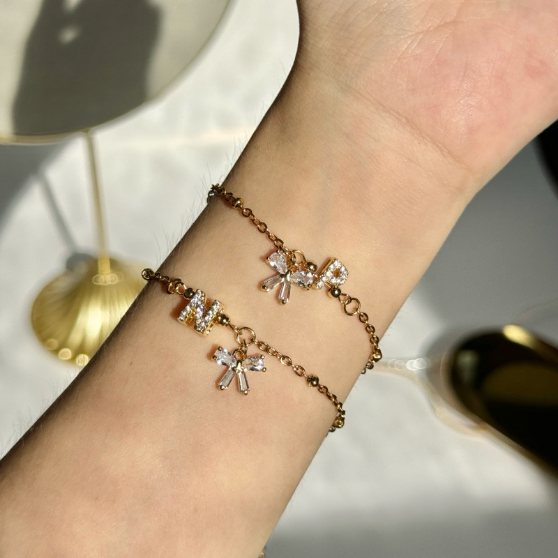 Alphabet Bow Gem Bracelet กำไลโบว์เพชรจี้ตัวอักษร | @trophies.co
