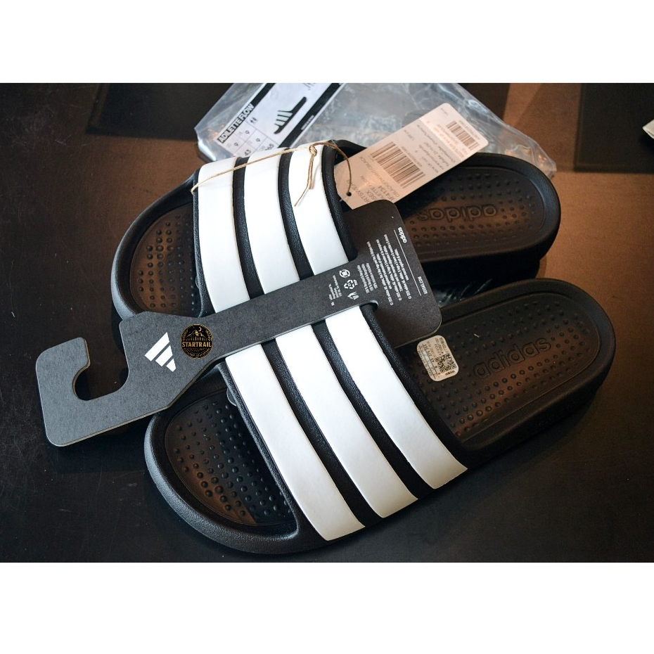 รองเท้าแตะผู้ชายแบบสวม สินค้าลิขสิทธ์แท้ Adilette Flow Slides IF4134 Core Black / Cloud White / Core