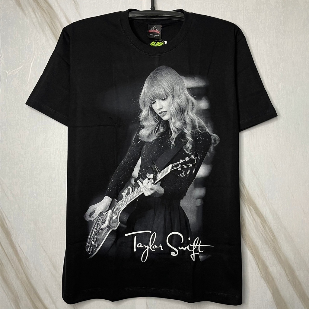 เสื้อยืด Taylor Swift เทย์เลอร์ สวิฟต์ เล่นกีต้าร์ หลังเล่นเปียโน คุมโทนเทาดำ (ป้าย RockTees เรืองแส