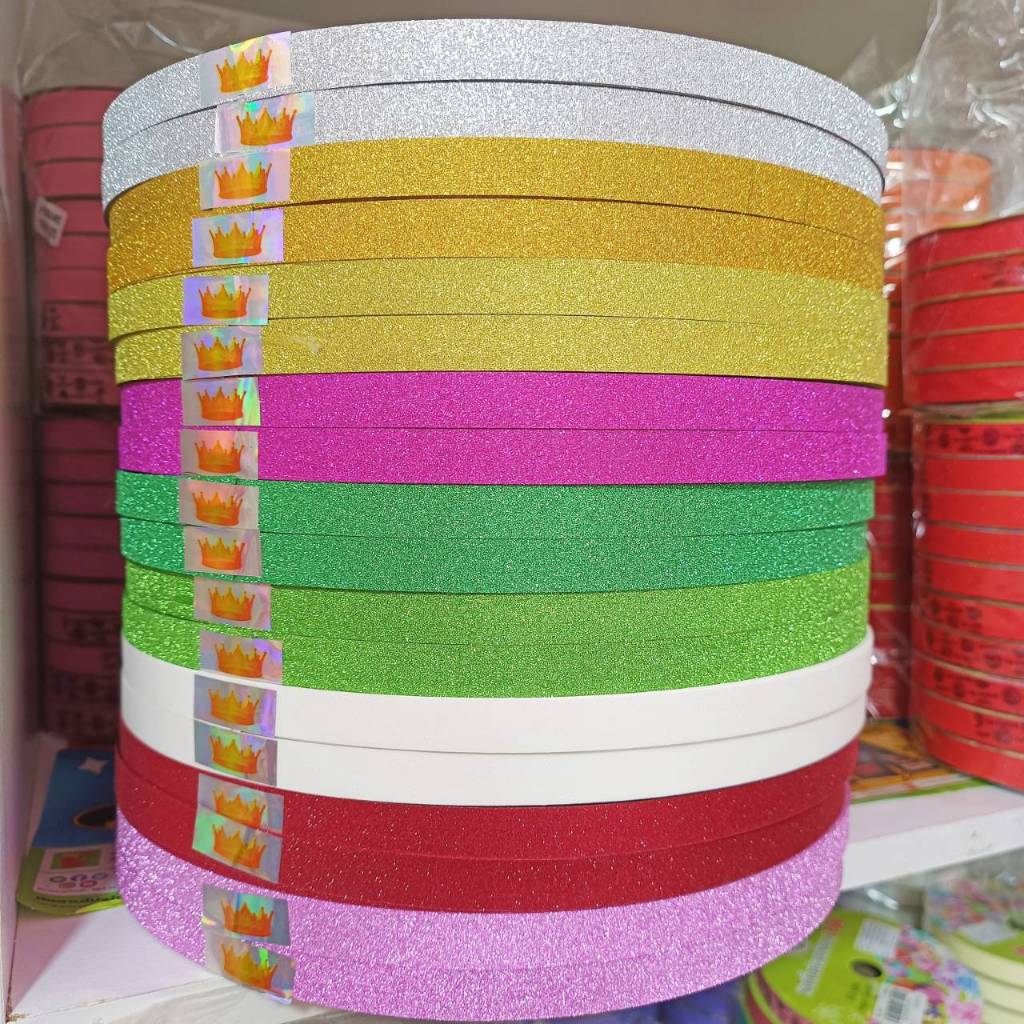 ริบบิ้นกากเพชรหยาบ ตรามงกุฎ กากเพชรทึบเนื้อแข็ง ม้วนใหญ่ยาว 270 หลา ขนาด12mm. สำหรับพับเหรียญโปรยทาน