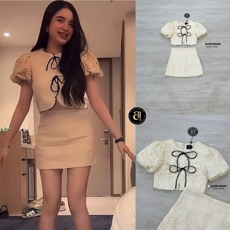 Aileen เสื้อคอป ลูกไม้สีครีม แขนสั้น แต่งจั้มสม๊อคแขน ดีเทลแต่งสายผู้โบว์หน้า มีซิปหลัง แมทซ์กับกระโปรงสั้นลูกไม้