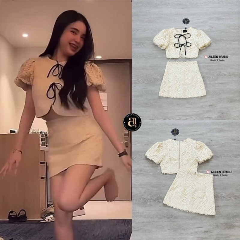 Aileen เสื้อคอป ลูกไม้สีครีม แขนสั้น แต่งจั้มสม๊อคแขน ดีเทลแต่งสายผู้โบว์หน้า มีซิปหลัง แมทซ์กับกระโปรงสั้นลูกไม้
