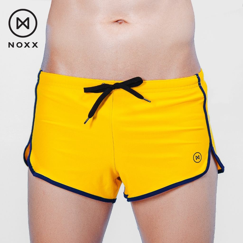 Noxx Swim Shorts: กางเกงว่ายน้ำ ขาสั้น สีเหลือง กุ๊นขอบสีน้ำเงิน