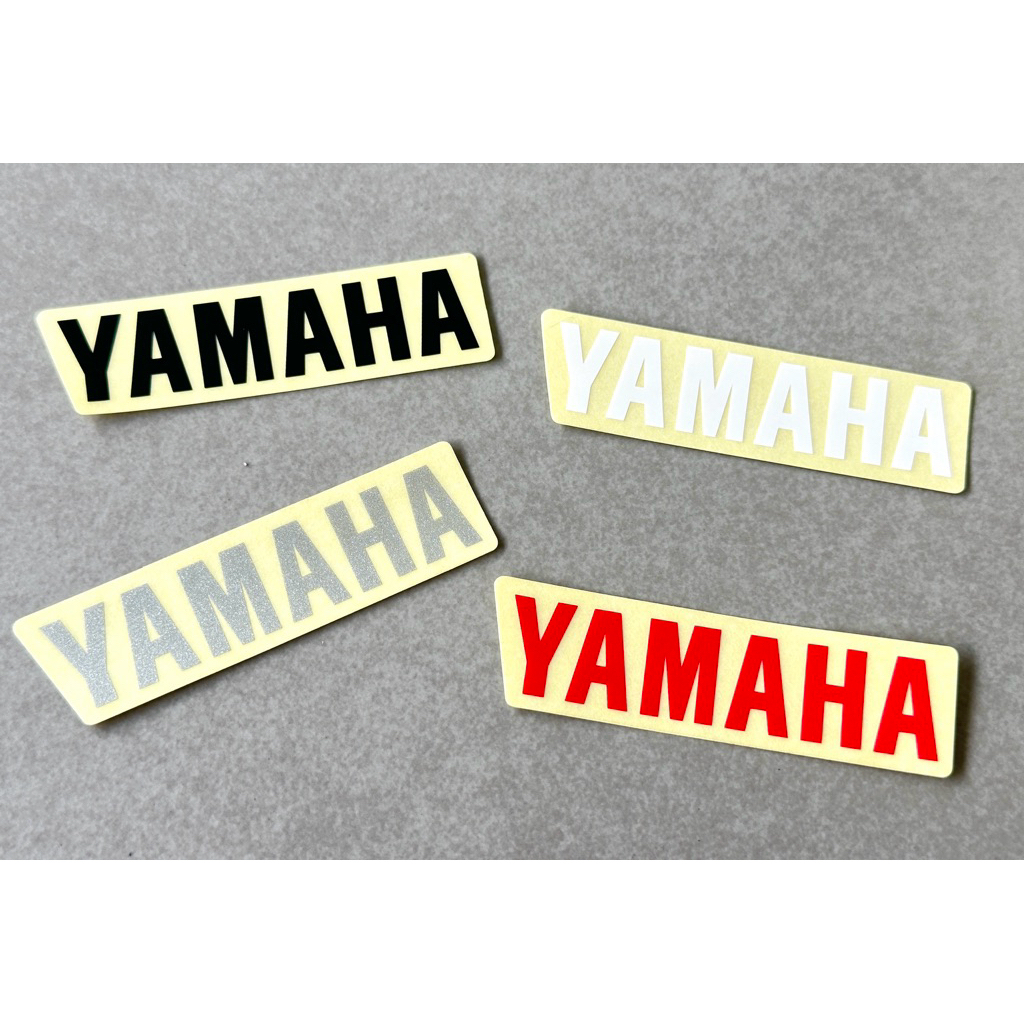 สติ๊กเกอร์ YAMAHA  แท้ศูนย์  ( แปะฝาท้าย Nouvo MY )  ขนาด ความยาว 10 ซม  สูง 2 ซม . ราคา ถูกที่สุด ดีลบีเคเค รูปภาพหลัก