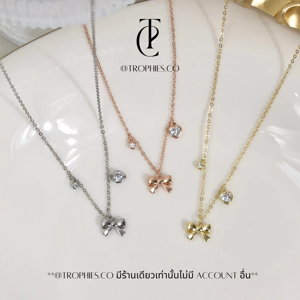TROPHIES.CO - Baby ribbon necklace สร้อยคอโบว์ หัวใจ เพชร