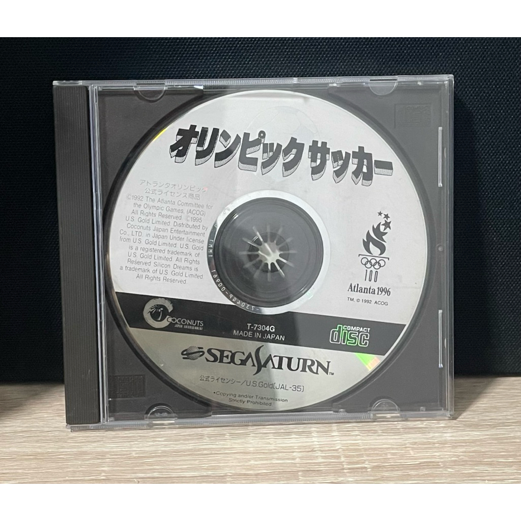 แผ่นเกม "Olympic Soccer" (オリンピックサッカー) เวอร์ชันภาษาญี่ปุ่นสำหรับเครื่อง Sega Saturn ซึ่งเป็นเกมฟุตบอล