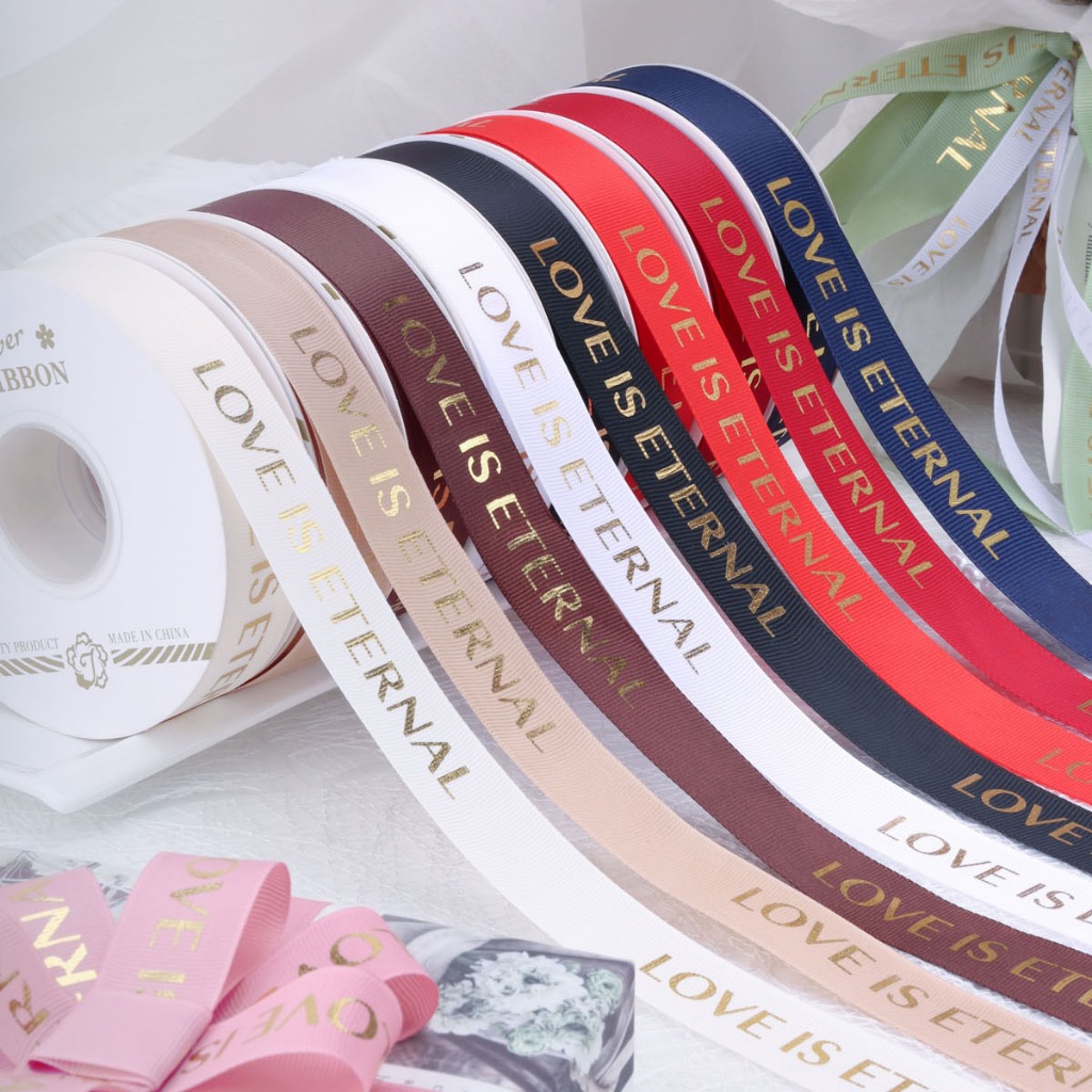 ริบบิ้นผ้าซาติน LOVE IS ETERNAL กว้าง 2.5 ซม. ยาว 30 หลา พิมพ์ลายสีทอง (สินค้าพร้อมส่ง)
