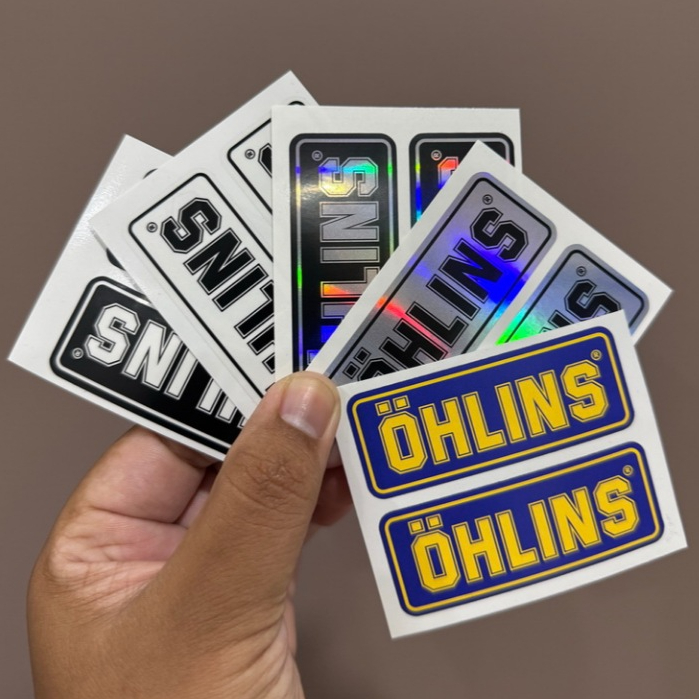 1 คู่ ลาย OHLINS ขนาด 2.7 x 6.9 cm. สติ๊กเกอร์ ติดโช๊ค ติดกระป๋องโช๊ค รถมอเดอร์ไซค์ แต่งโช๊ค ราคา ถูกที่สุด ดีลบีเคเค