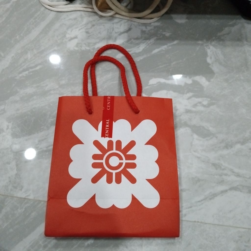 ถุงช้อปปิ้งสีส้มแดงในภาพคือถุงจากห้างสรรพสินค้าเซ็นทรัล (Central Department Store)