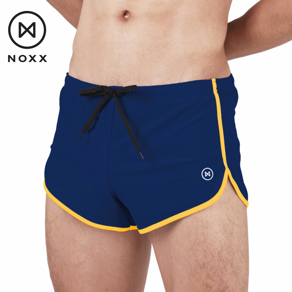 Noxx Swim Shorts: กางเกงว่ายน้ำ ขาสั้น สีน้ำเงิน กุ๊นขอบสีเหลือง