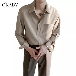 OKADY ใหม่ เสื้อเชิ้ตแขนยาวผู้ชายสไตล์เกาหลีนุ่มเรียบง่ายอินเทรนด์เสื้อเชิ้ตสีทึบไม่รีด