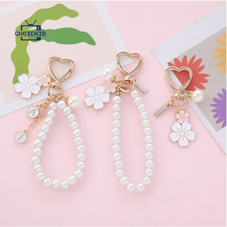 สายคล้องโทรศัพท์มือถือ จี้โทรศัพท์โลหะรูปดอกไม้คู่ จี้กล่องหูฟังไข่มุกตัวอักษรน่ารัก จี้กระเป๋าสุดสร้างสรรค์ พวงกุญแจ