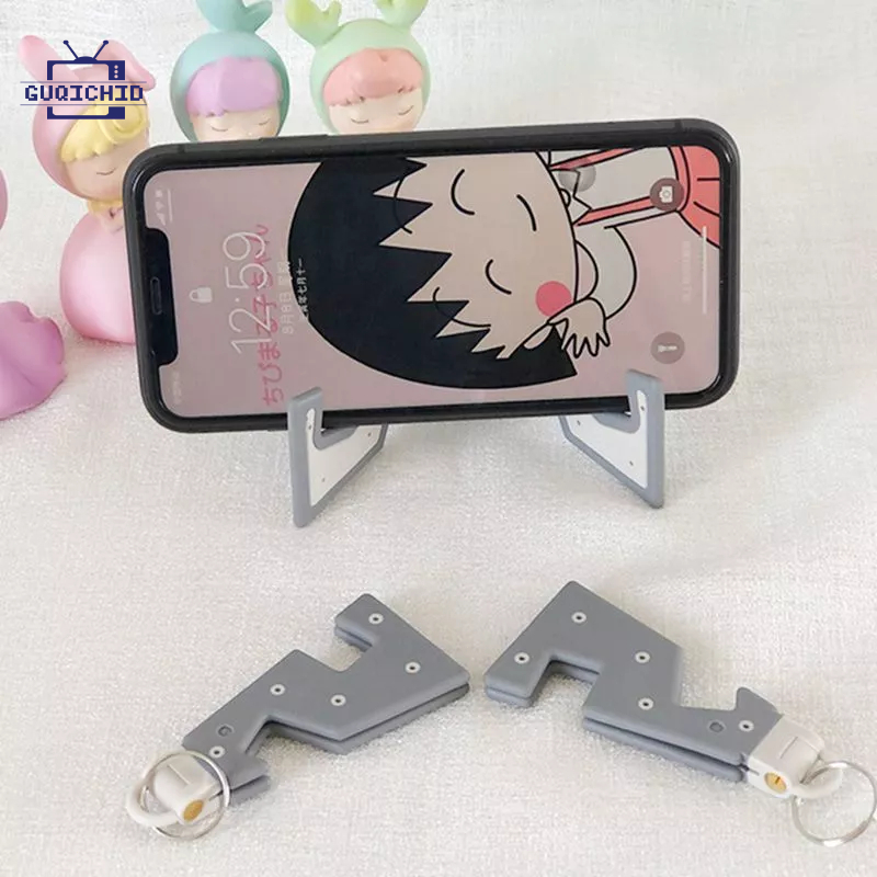 IKEA พวงกุญแจที่วางโทรศัโต๊ะแบบพกพาที่วางโทรศัพท์มือถือพวงกุญแจสร้างสรรค์พับขาตั้งโทรศัพท์ขาตั้งคอมพิวเตอร์แบบพกพาพับได้