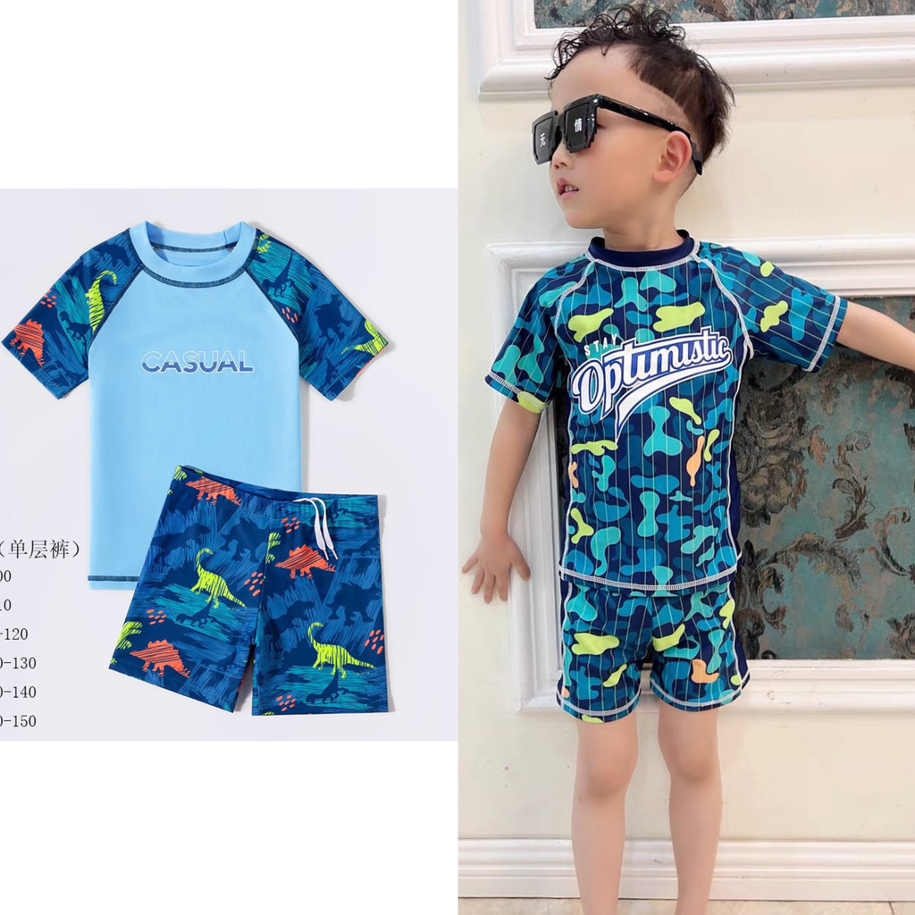 Stay Optimistic navy ชุดว่ายน้ําหลวมสําหรับชายรัสเซีย Fish B1R4C0 - YUKE ไดโนเสาร์สีเขียวชุดว่ายน้ํา