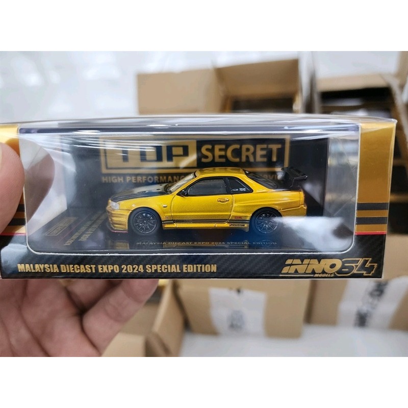 Nissan Skyline GT-R (R34) รุ่นรถ Top Secret Tokyo 2024 1:64 INNO (ทอง)